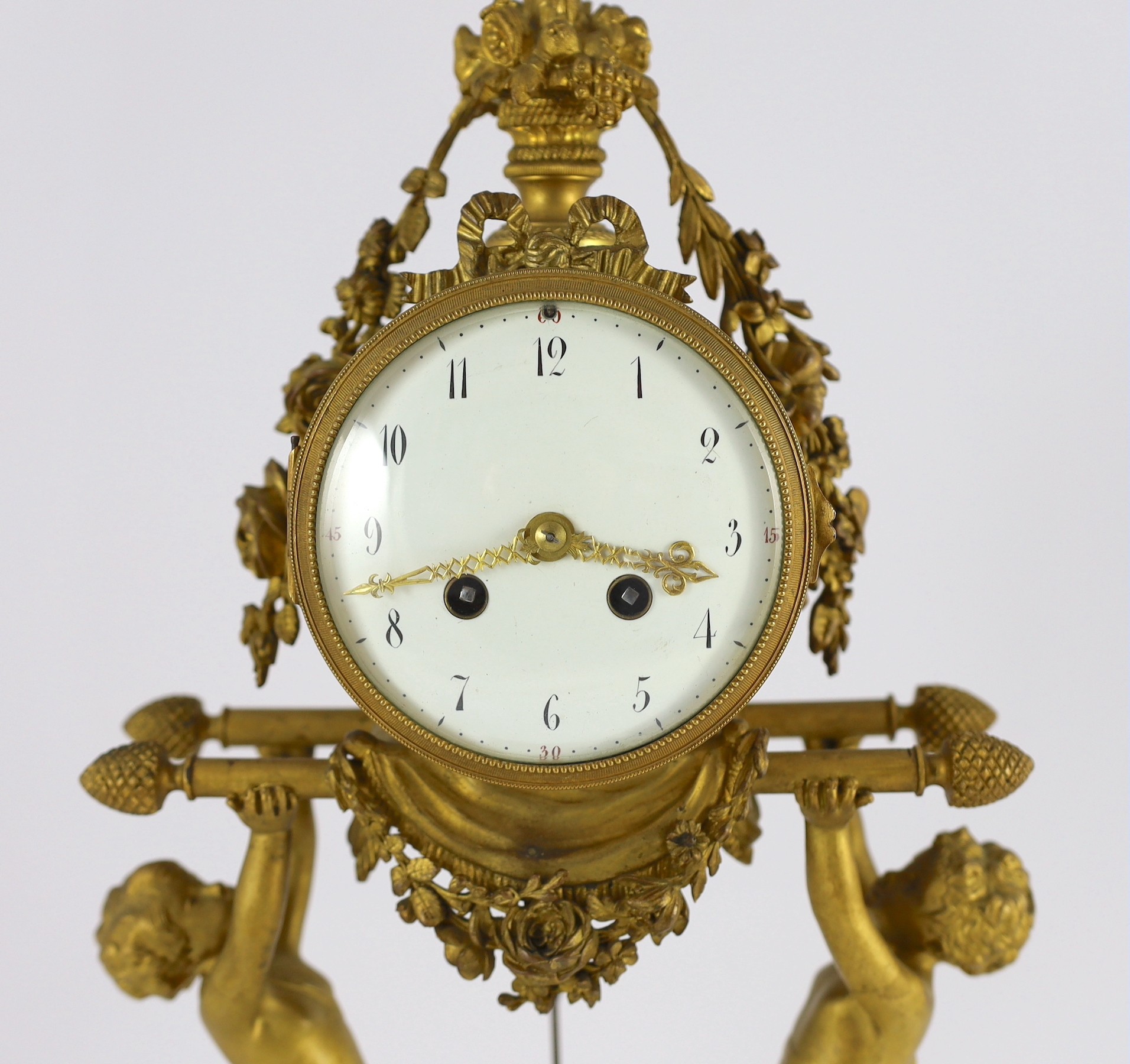A French Louis XVI style ormolu and white marble mantel clock, 26cm wide, 48cm high